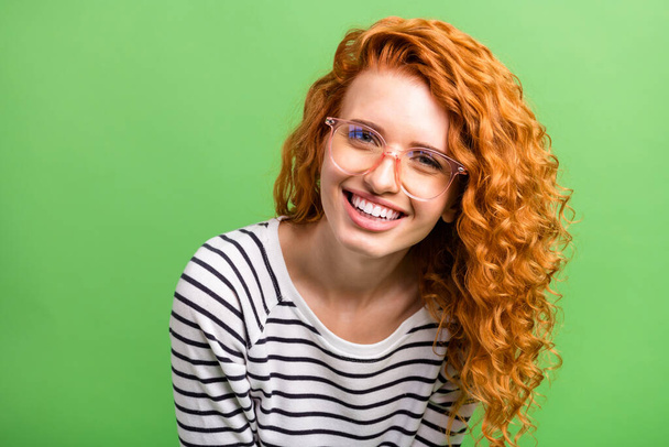 Photo of shiny adorable young lady dressed striped clothes arm glasses smiling isolated green color background - Foto, immagini