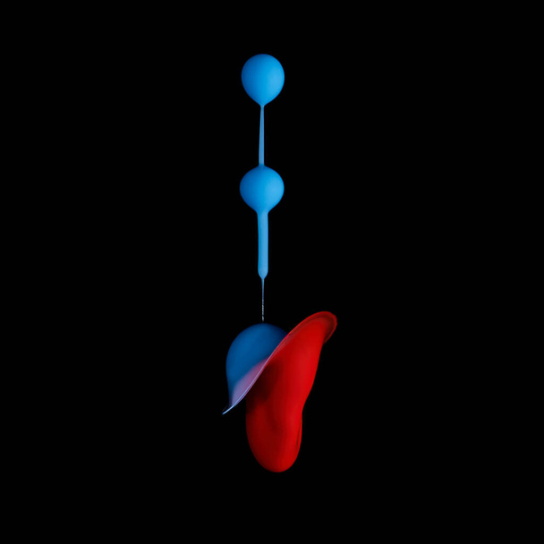 Three blue acrylic paint drops falling from above combining with a red drop pressure shot up from below - Liquid Drop Art - Photo, Image