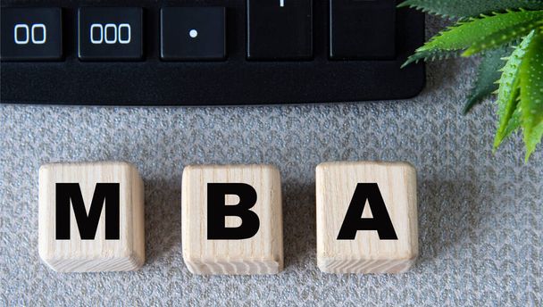MBA - acronym on wooden cubes on a gray background with a calculator. Business concept - Фото, зображення