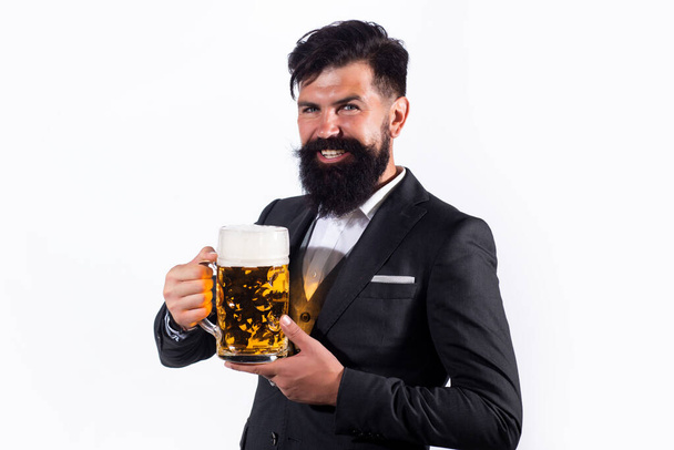 Handsome man in black suit drinking beer over white background. - Фото, зображення