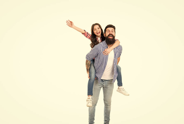 My father is super. Father carry daughter piggyback. Little child and father have fun together. Happy family in photo studio. Fathers day. Enjoy time and funny activities. My father is my friend - Foto, imagen
