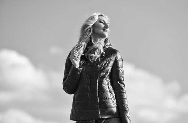 lifestyle concept. trendy girl in casual fall coat. autumn and spring style. Young and beautiful woman over sky background. above the clouds. looking far away, sense of freedom. future and success - Foto, afbeelding