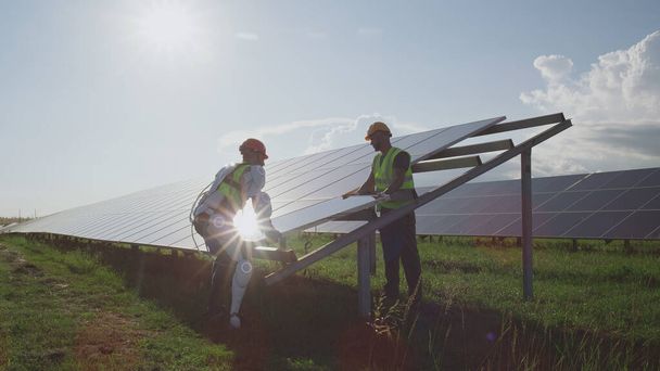 Ingenieros masculinos instalando paneles solares juntos - Foto, imagen