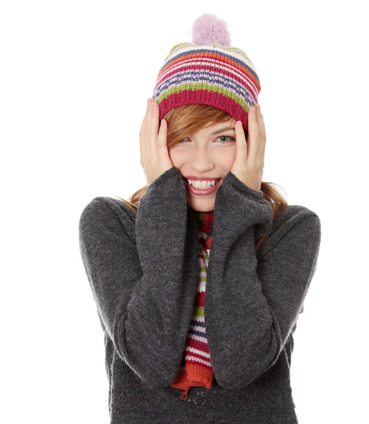 Close up of young woman with winter cap smiling at the camera isoalted on white background - Photo, Image