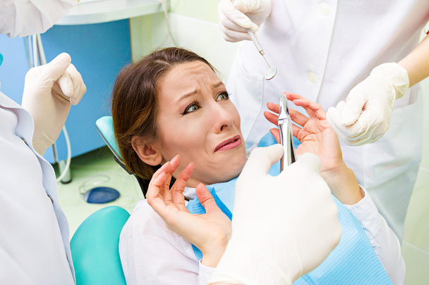 Female patient in dentist office scared, afraid of doctor, proce - Foto, Imagen