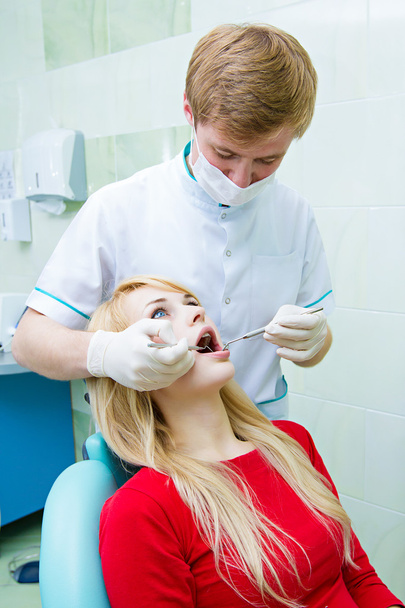 Dentist examining young adult patient - Valokuva, kuva