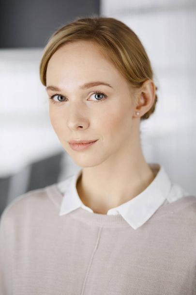 Friendly adult casual dressed business woman standing straight. Business headshot or portrait in office - Foto, Imagem