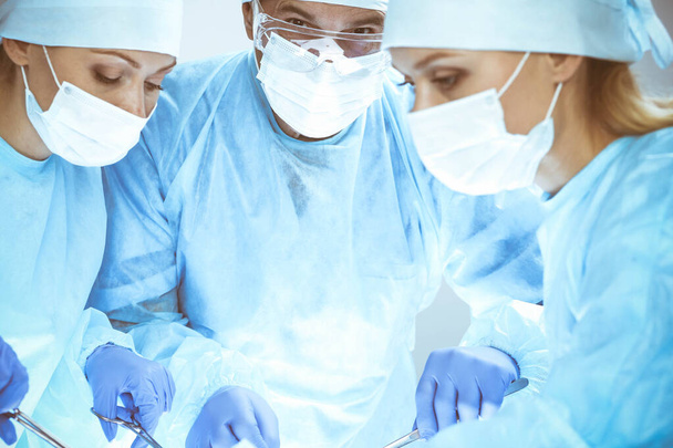 A group of surgeons is operating at the hospital. Health care concept - Zdjęcie, obraz