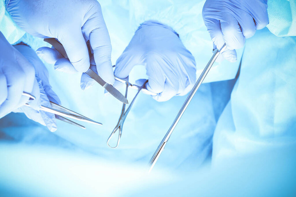 A group of surgeons is operating at the hospital, close-up of hands. Health care concept - Fotografie, Obrázek