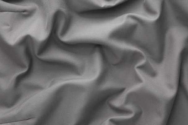 Crumpled gray silk fabric. Beauty fashion background - Foto, imagen