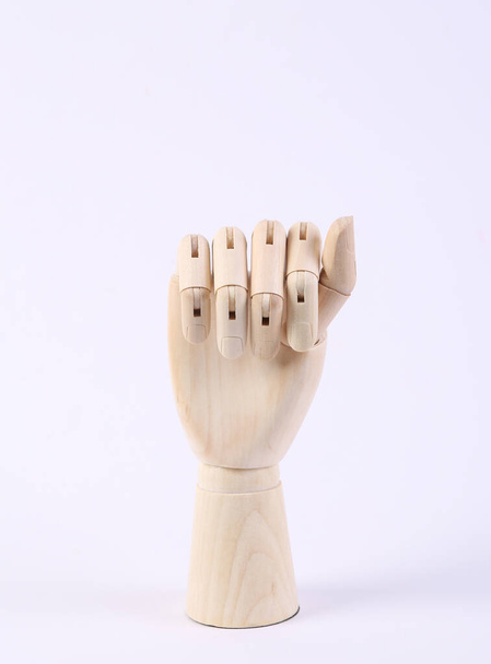 Wooden hand folded into fist on white background - Photo, Image