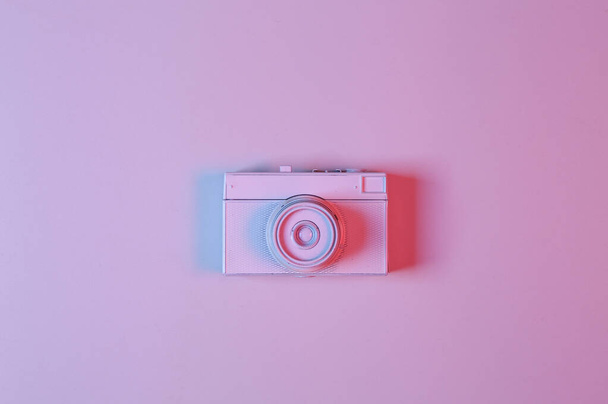 White film camera in pink-blue neon gradient light. Minimalism. Creative layout  - Φωτογραφία, εικόνα