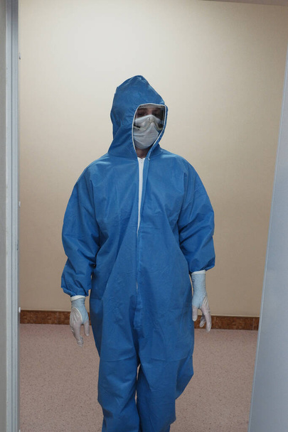 El trabajo de un radiólogo con monos antivirales en la sala de rayos X para el diagnóstico. - Foto, Imagen