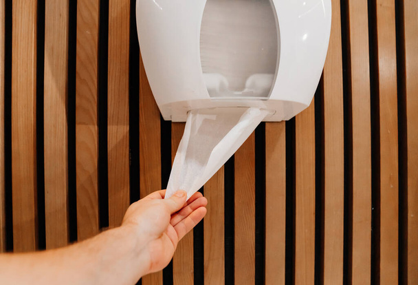 use of paper towels and toilet paper in a public toilet.  - Photo, image