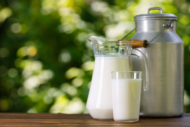 milk in glass and jug with metal can - Photo, image
