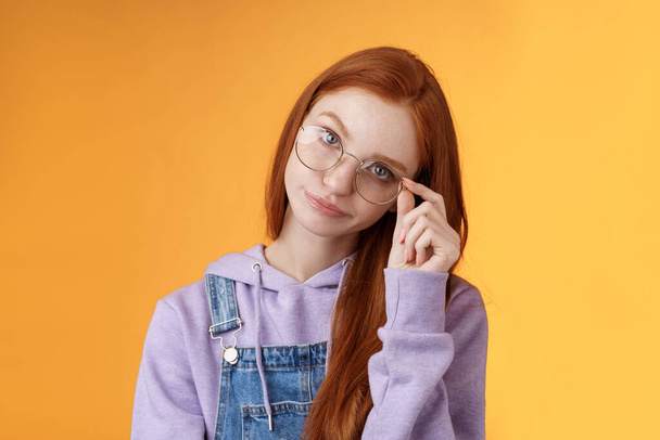 Annoyed bossy unimpressed bothered young redhead female coworker smirking tilting head irritated touch glasses look ignorant cringing stupid uninteresting doubtful story not buy any excuses - Fotoğraf, Görsel