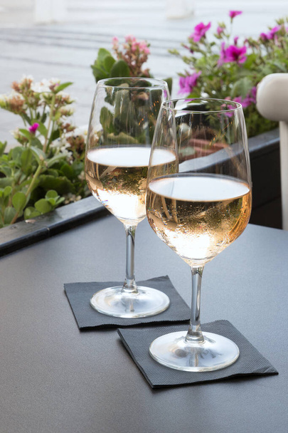 two glasses of wine rose in a restaurant on the street - Photo, Image