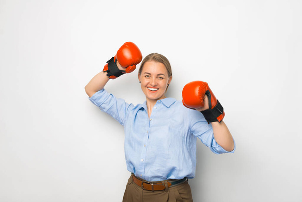 Young hispanic businesswoman with fighting spirit, in red boxing gloves over wihte background - Fotoğraf, Görsel