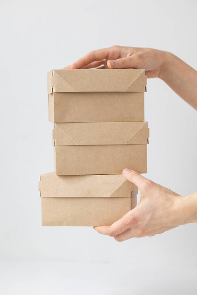 Kraft cardboard boxes, food or clothing delivery, modern ways to buy food with delivery - Foto, imagen