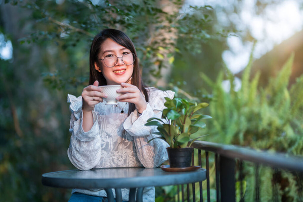 Happy of asian freelance people businessfemale hold a coffee cup mug casual working with laptop computer with Notebook and smartphone in coffee shop,Business Lifestyle communication concept - Photo, Image