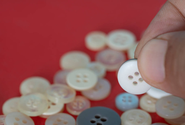Buttons of different sizes and shades of whites. Selective focus points. Blurred background - Photo, Image