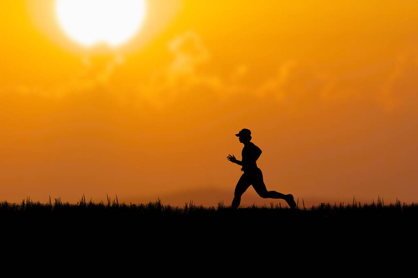 Silhouette of a runner practicing in the evening. Training ideas after the coronavirus crisis - Photo, Image