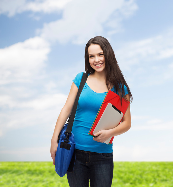 smiling student with bag, folders and tablet pc - Foto, Bild