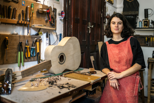 woman luthier making guitars in her musical instrument workshop - Photo, Image