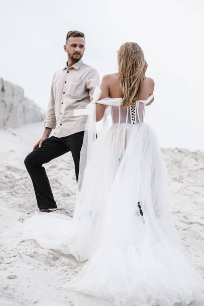 Beautiful wedding couple bride and groom at wedding day outdoors at ocean beach. Happy marriage - Fotoğraf, Görsel
