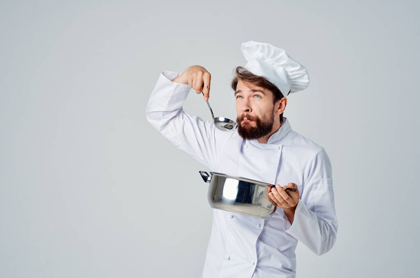 αρσενικό σεφ κρατώντας μια κατσαρόλα μαγείρεμα τροφίμων επαγγελματική κουζίνα - Φωτογραφία, εικόνα