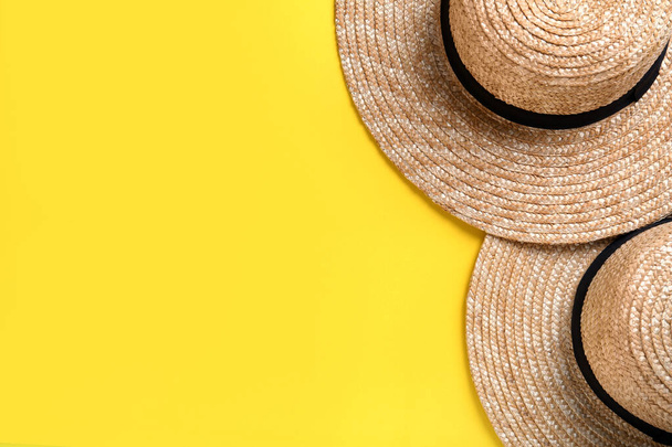 Stylish straw hats on yellow background, flat lay. Space for text - Fotoğraf, Görsel