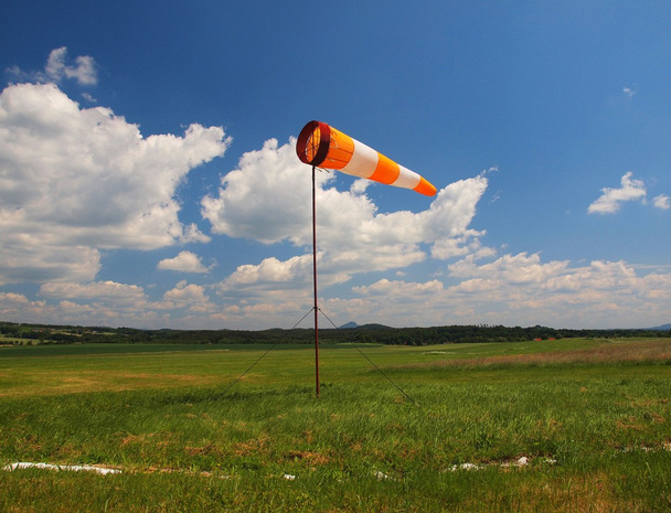 Yaz spor Havaalanı ile terk edilmiş windsoc sıcak günde, Rüzgar esiyor ve Rüzgar gülü hareket ediyor - Fotoğraf, Görsel