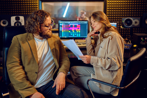 Musicians at mixing console, recording studio interior on background. Synthesizer and audio mixer, musician workplace, creative process, song record - Foto, Imagem