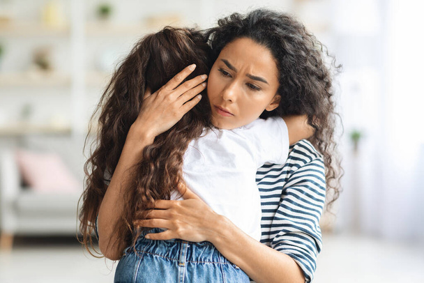 Madre cariñosa abrazando a su pequeña hija llorando - Foto, Imagen