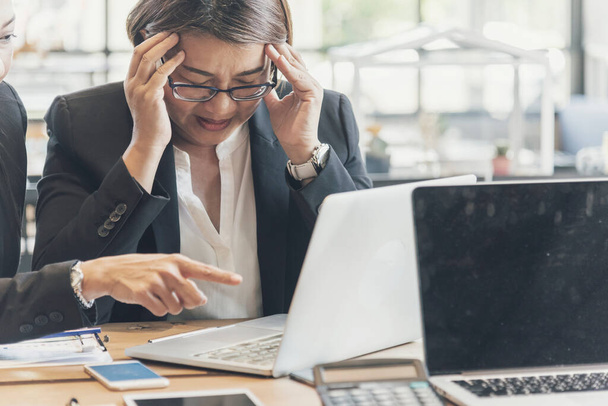 アジア人の実業家は深刻な問題でオフィスでストレスの多い不安を克服した。会社のオフィスでは女の疲労感や精神的な焦りが疲れを感じます。ストレス悲しみ熟考 - 写真・画像