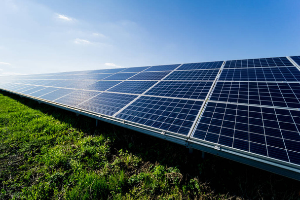 Photovoltaic solar panels on blue sky background - Φωτογραφία, εικόνα