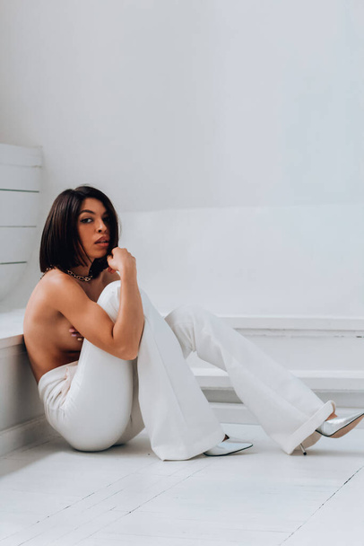 Sexy nude girl in white pants - Фото, изображение