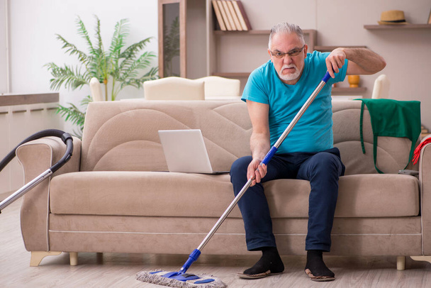Yaşlı adam evi temizliyor. - Fotoğraf, Görsel