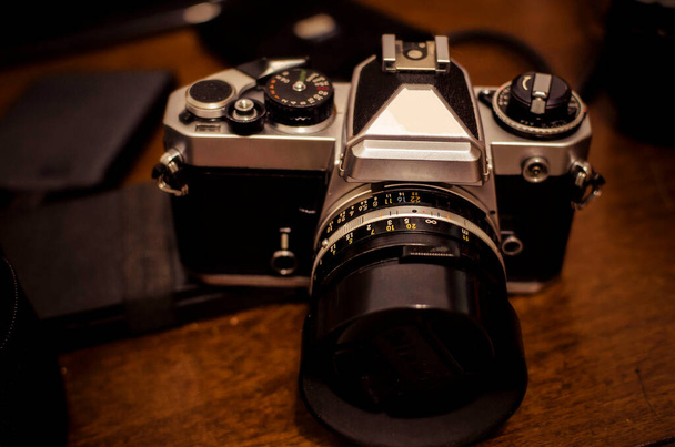 SLR analog camera on a messy tabl - Fotó, kép