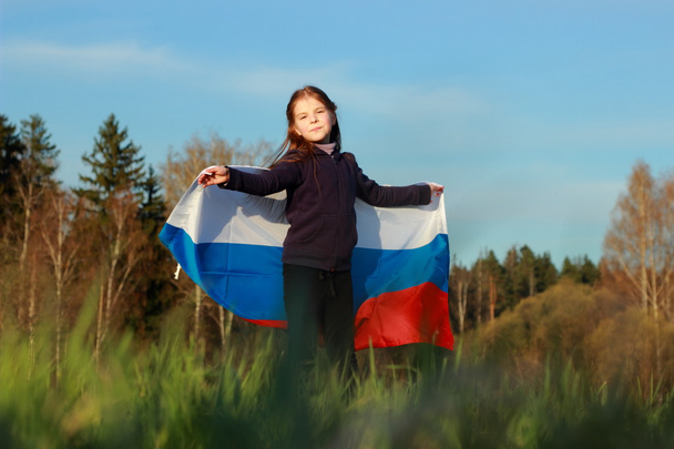 Beautiful little girl with Russian flag - 写真・画像