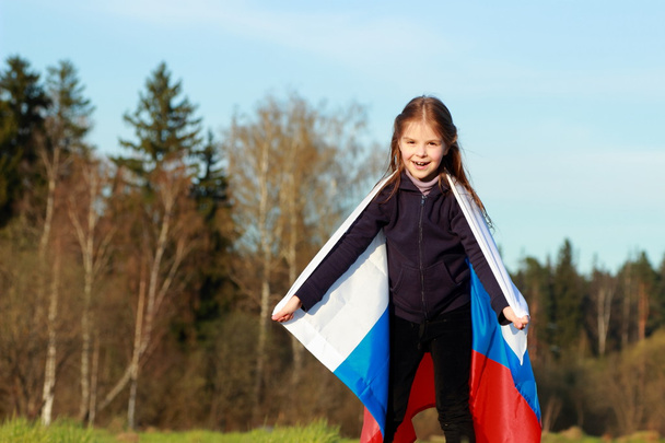 Beautiful little girl with Russian flag - Foto, imagen