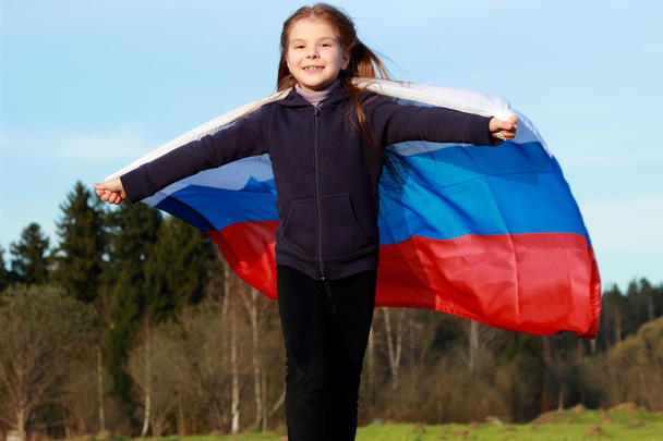 Girl holding a large Russian flag - 写真・画像