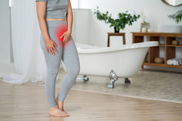 Έμμηνος πόνος, γυναίκα με στομαχόπονο που υποφέρει στο σπίτι, επώδυνη περιοχή τονισμένη με κόκκινο - Φωτογραφία, εικόνα