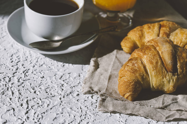 delicious fresh French croissants with cup of coffee   - Photo, Image