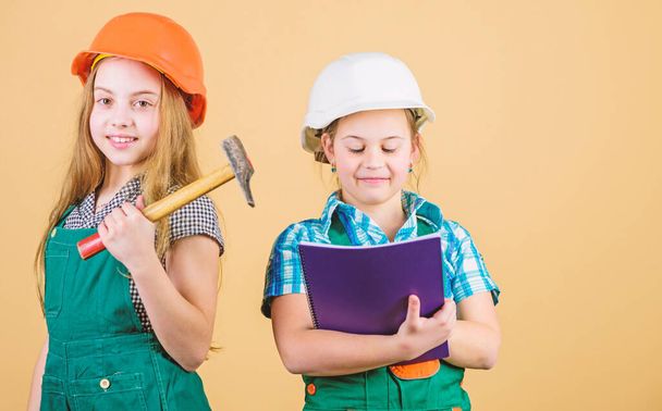 Foreman inspector. Repair. happy children. Future career. Little kids in helmet with tablet and hammer. Labor day. 1 may. small girls repairing together in workshop. Tired after hard working day - Foto, Imagen