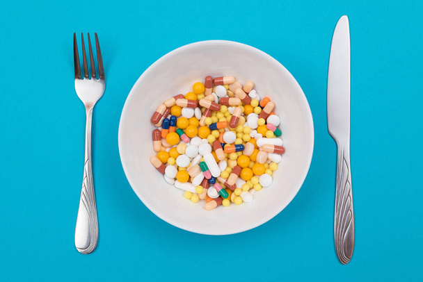 Pharmaceutical Industry and Medicinal Products - Colored Pills on Plate - Foto, afbeelding