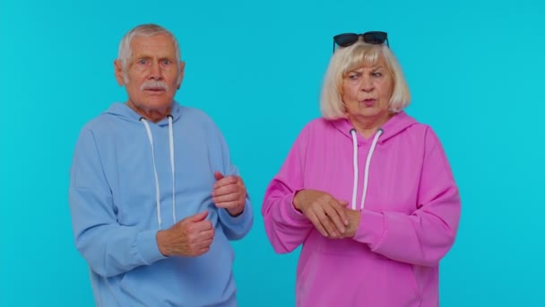 Displeased senior old couple man woman grandparents gesturing hands with irritation and displeasure - Footage, Video