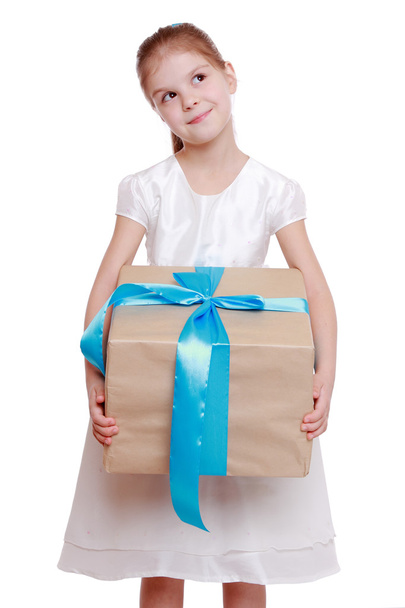 Girl in a white dress holding a big gift box - 写真・画像