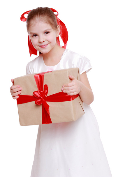 Girl in a white dress holding a big gift box - Photo, Image