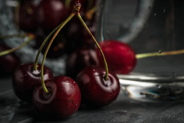 Fresh juicy cherries. Red cherry on a dark background. Macro photo. - Фото, зображення